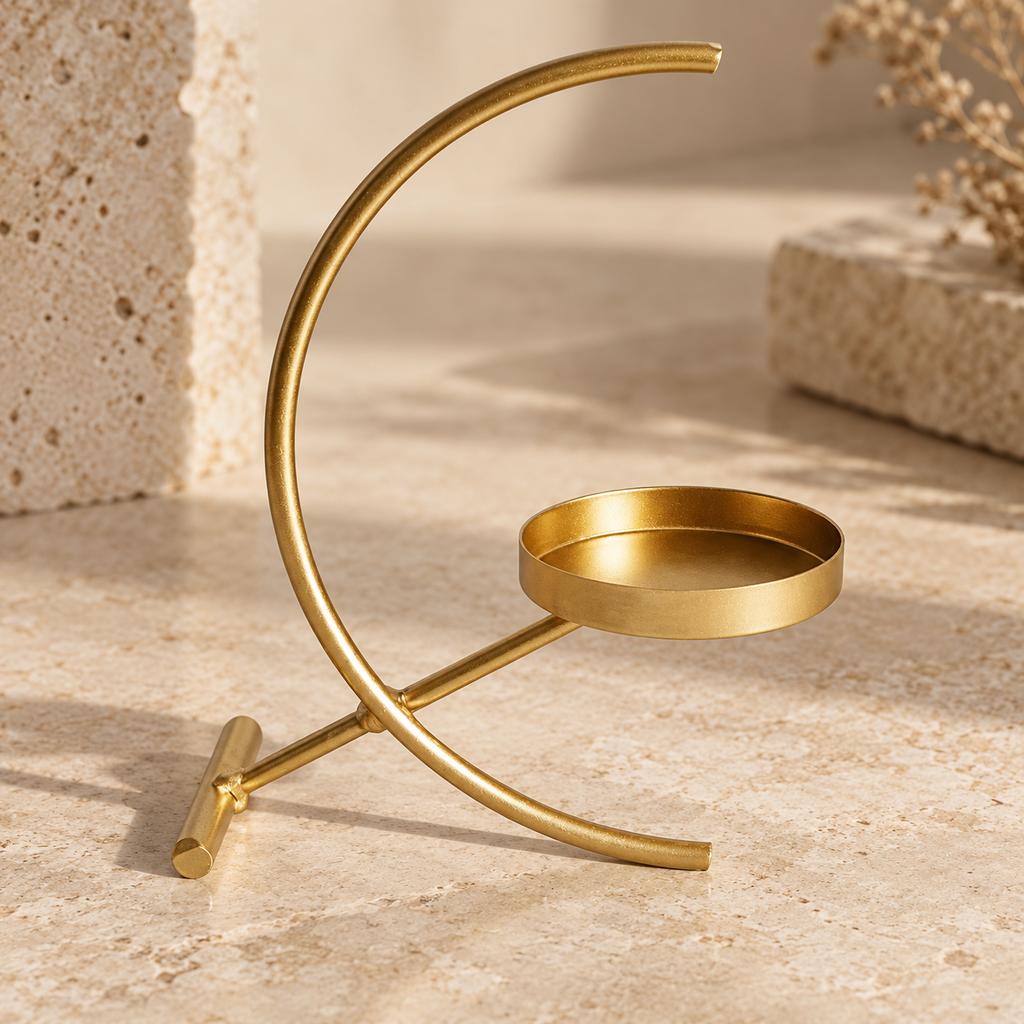 Crescent gold-tone tealight holder — detail view; candle and styling props not included