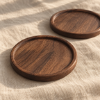 Round walnut coaster pair — detail view