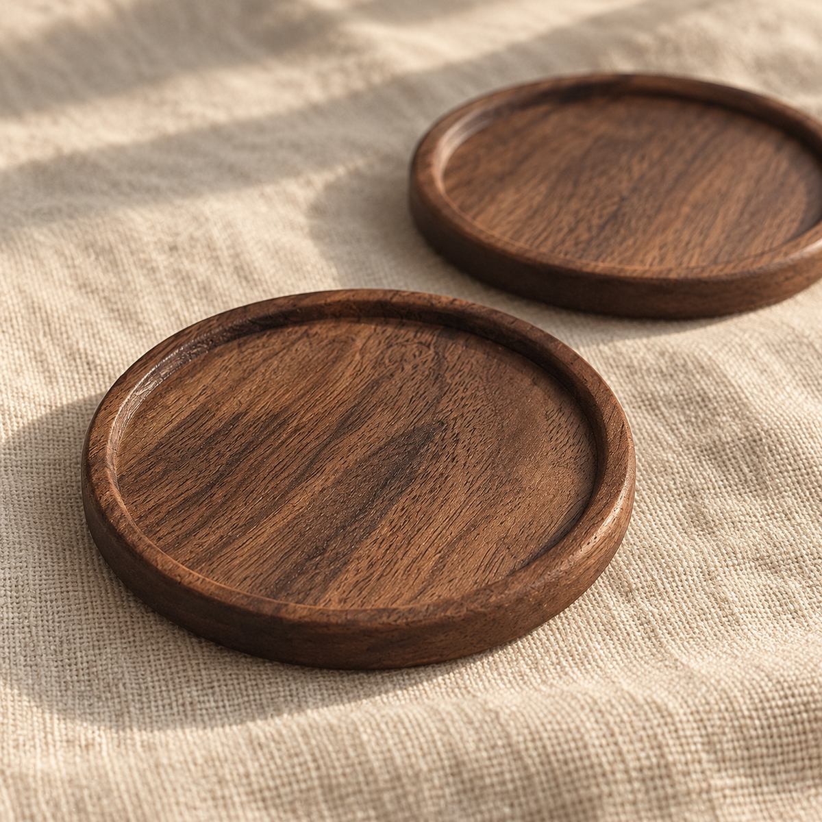 Round walnut coaster pair — detail view